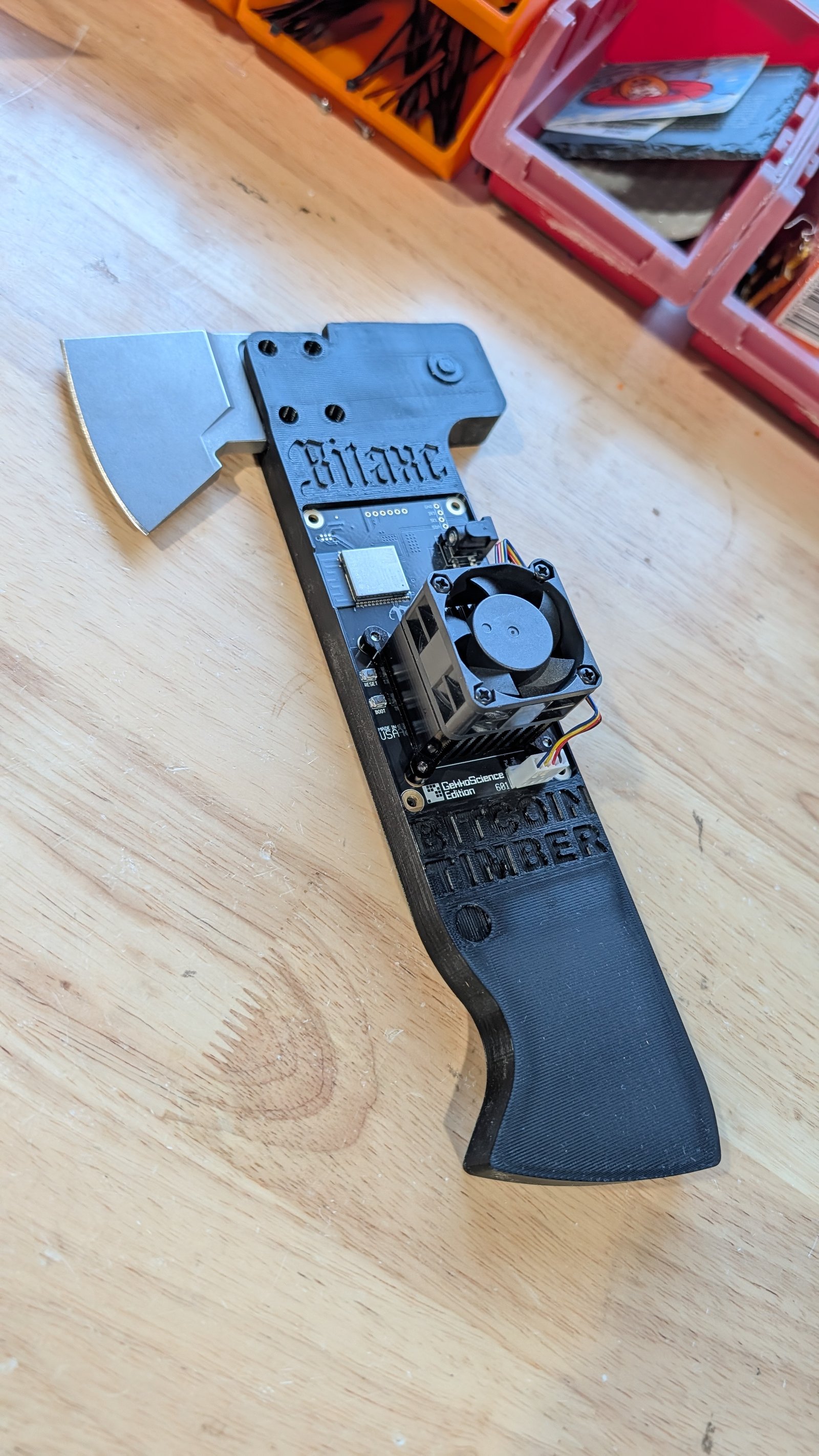 The printed TimberAxe on the bench — Bitaxe board, fan, and edition label